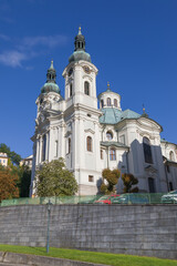 White catholic Church of St. Mary Magdalene (or Maria Magdalena) in Karlovy Vary, Czechia. Sunny day, bright blue sky. Low angle view. Church was built by architect Kilian Ignaz Dientzenhofer in 1737.