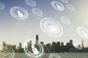 Double exposure of social network icons hologram on San Francisco office buildings background. Networking concept