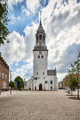 Fototapeta na wymiar traditional white church tower with gold clock