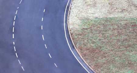 Fragment of an asphalt ring road with white road markings