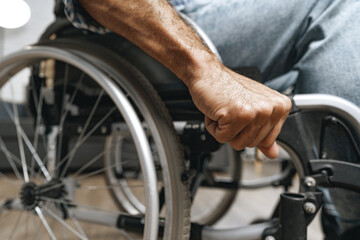 Obraz premium Unrecognizable disabled man sitting in a wheelchair