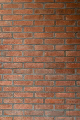 Smooth red brick wall. Texture wallpaper. Vertical shot.