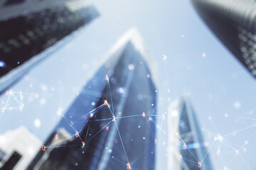 Double exposure of abstract virtual technology hologram on modern skyscrapers background. Research and development software concept