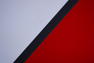 Red and white diagonally divided background with black stripe