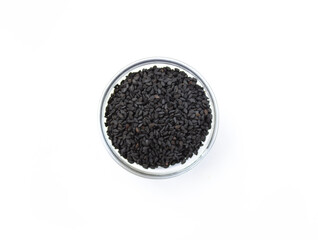 Black sesame seed in glass bowl on white isolated background, top view