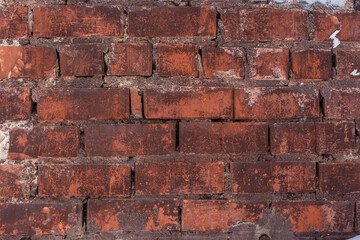 Aged red brick wall texture with traces of paint