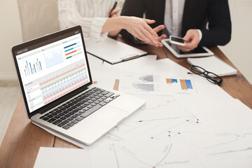 Business team making business prognosis, using laptop