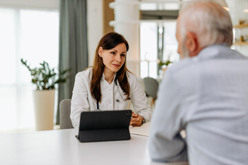 Caring doctor listening to a senior patient.