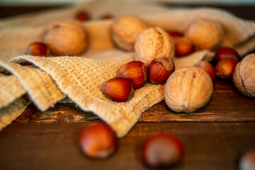nuts and towel on wooden background