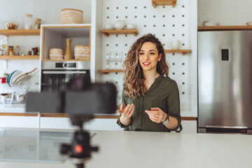 Young woman recording a video at home.