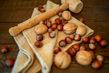 nuts and towel on wooden background