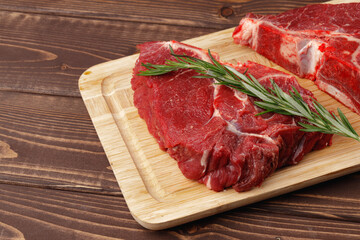 Beef tenderloin on wooden board on wooden table