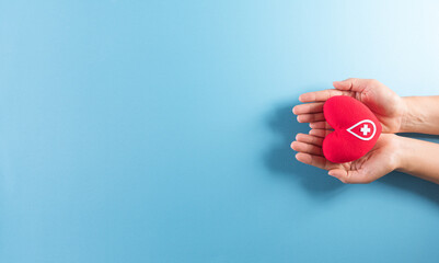 Medical and donor concepts. Hand holding a handmade red heart with a sign or symbol of blood...