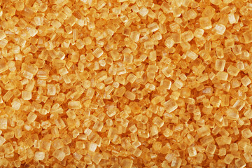 Texture of golden sand on the beach with a solid background in full screen