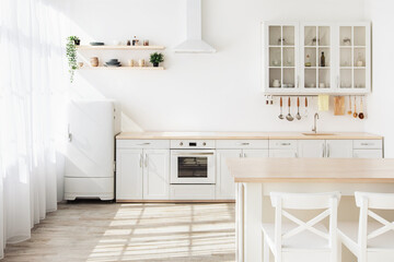 Light kitchen interior with white furniture and shelves, small refrigerator near window, empty space - Powered by Adobe