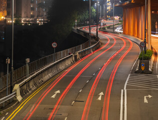 Light trails of traffic on road at night. Transportation background