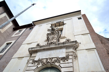 monumental entrance to the old house with stone frame and papal coat of arms (pope Clement XIII) -...