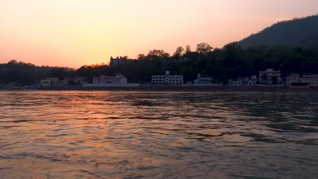 River Ganga and town buildings at sunset, time lapse