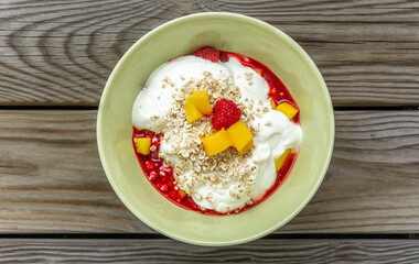 Healthy bowl with plenty vitamins in fruit and oats