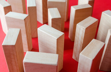 Wooden blocks on a red background. Concept of a maze labyrinth of wardrobes or dense urban...