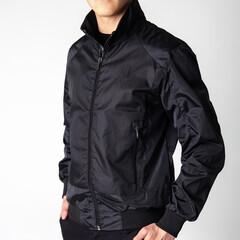 black men's windbreaker jacket on model on white background - obrazy, fototapety, plakaty