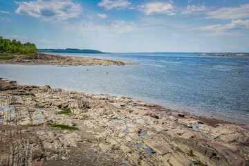 The rocky beach of the St Lawrence river in Berthier Sur Mer, a small town in the province of Quebec (Canada)