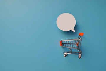 A shopping cart and a conversational cloud above it with a place under the inscription.