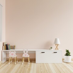 Children's room with cream colored walls is blank. There were books, colored pencils and lamps on the table and a chair and a tree on the floor.3d rendering.