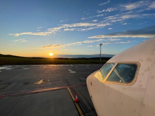 Airplane nose against beautiful sunrise