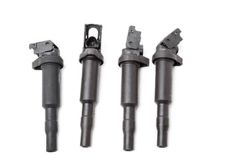 Four ignition coils for an internal combustion engine of a car during repair and service on a white...