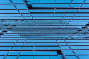 underside panoramic and perspective view to steel blue glass high rise building skyscrapers, business concept of successful industrial architecture