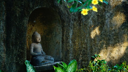 smiling buddha statue in the garden