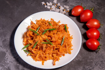 Stewed cabbage with onions and tomatoes is one of the most popular dishes. Homemade stewed cabbage with tomatoes and spices. View from above