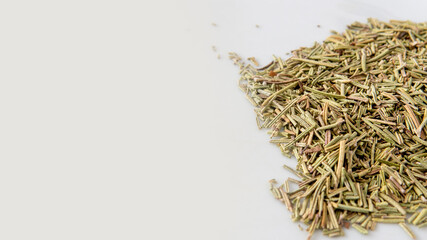 dried rosemary over a white background with copy space