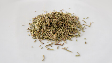 Close view of a bunch of dried rosemary over a white surface