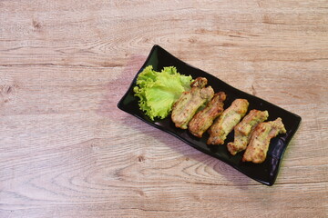 roasted barbecue chicken rib with pepper and garlic on plate eat couple fresh lettuce vegetable salad