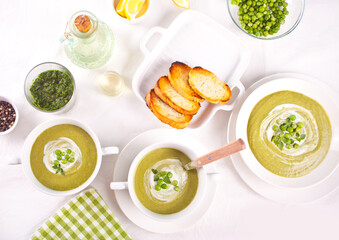 Delicious vegetable soup with potato, broccoli, green pea and spinach on the dinner table