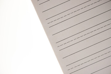 sheet of ruled card-stock paper with guide lines used for practicing calligraphy or fancy letter work - macro lens, shallow depth of field 