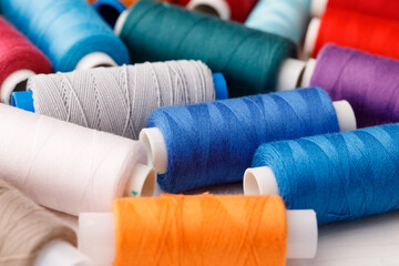 Fototapeta na wymiar Close up of colored thread coils, thread spools background