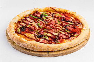 Isolated barbecue pizza with salami on a wooden board