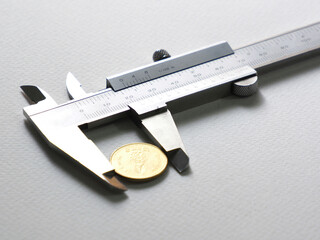 Vernier caliper in white background.