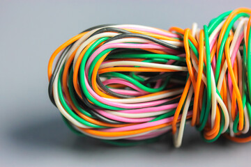 A bundle of multicolored electrical, car, computer, telephone twisted wires.