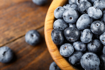 Juicy and fresh blueberries on a rustic table. Vegan and vegetarian concept.