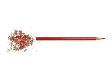 Sharpened red pencil with sawdust on a white background