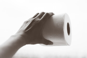 Toilet paper rolls hand holding toilet paper isolated white background. Personal hygiene 