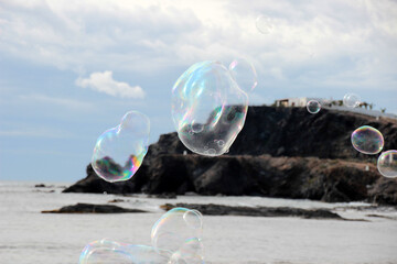 Large soap bubbles flying over the sea at Cabo de Palos