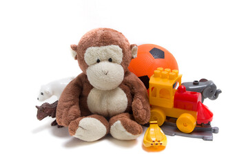 Children's toys on a white background. Constructor, ball and soft toys for children's development