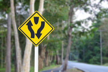 Split direction traffic sign blur background.