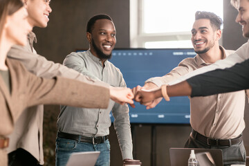 Portrait of smiling diverse business people giving fist bump