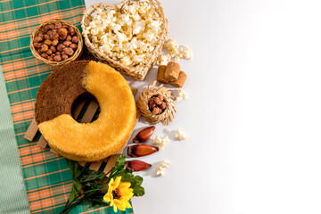 June party table. Typical Brazilian feast of June. Cake, peanuts, popcorn and pine nuts. Top view.